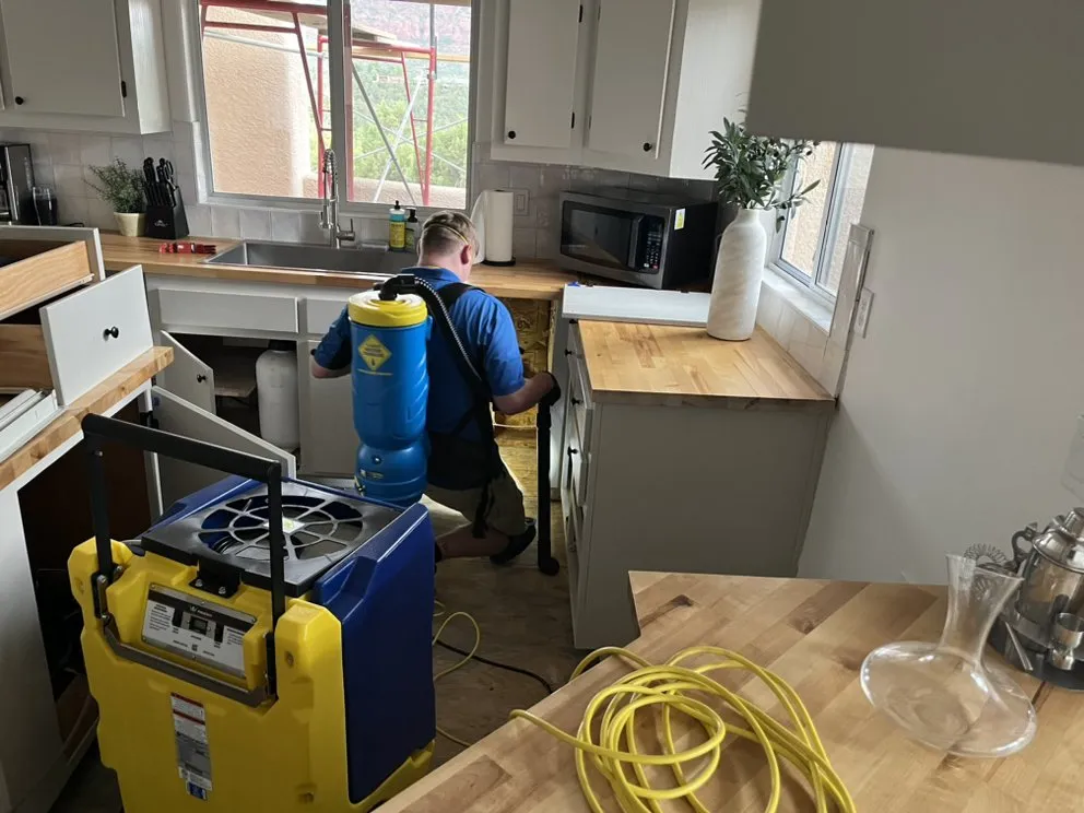 Structural drying and dehumidification equipment deployed in a water-damaged home with commercial air movers